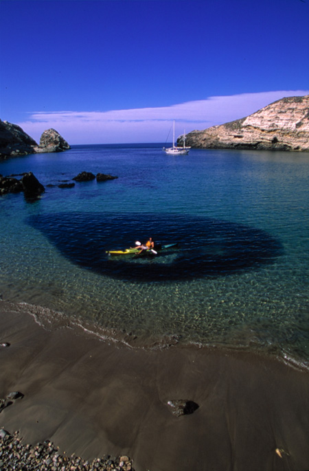 Kayaker above “bait ball” of fish, Santa Cruz Island by Chuck Graham