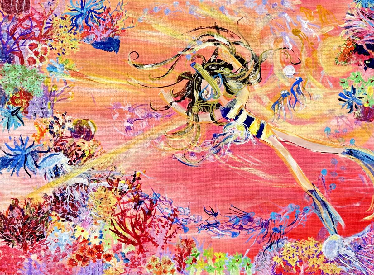 A girl snorkels in a colorful ocean full of life.