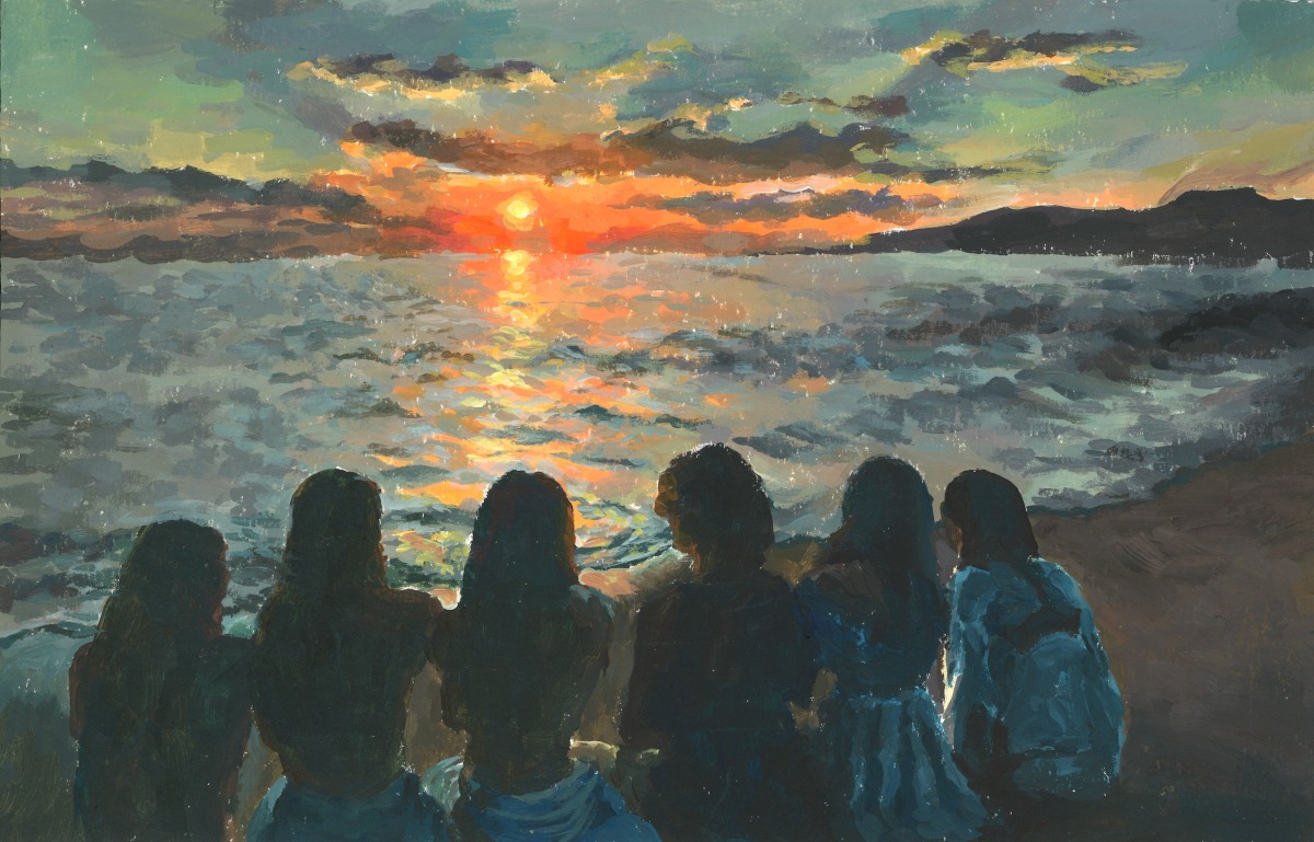 Six people sit close together on a beach with their backs turned. They are facing towards the ocean as the sun sets on the horizon.