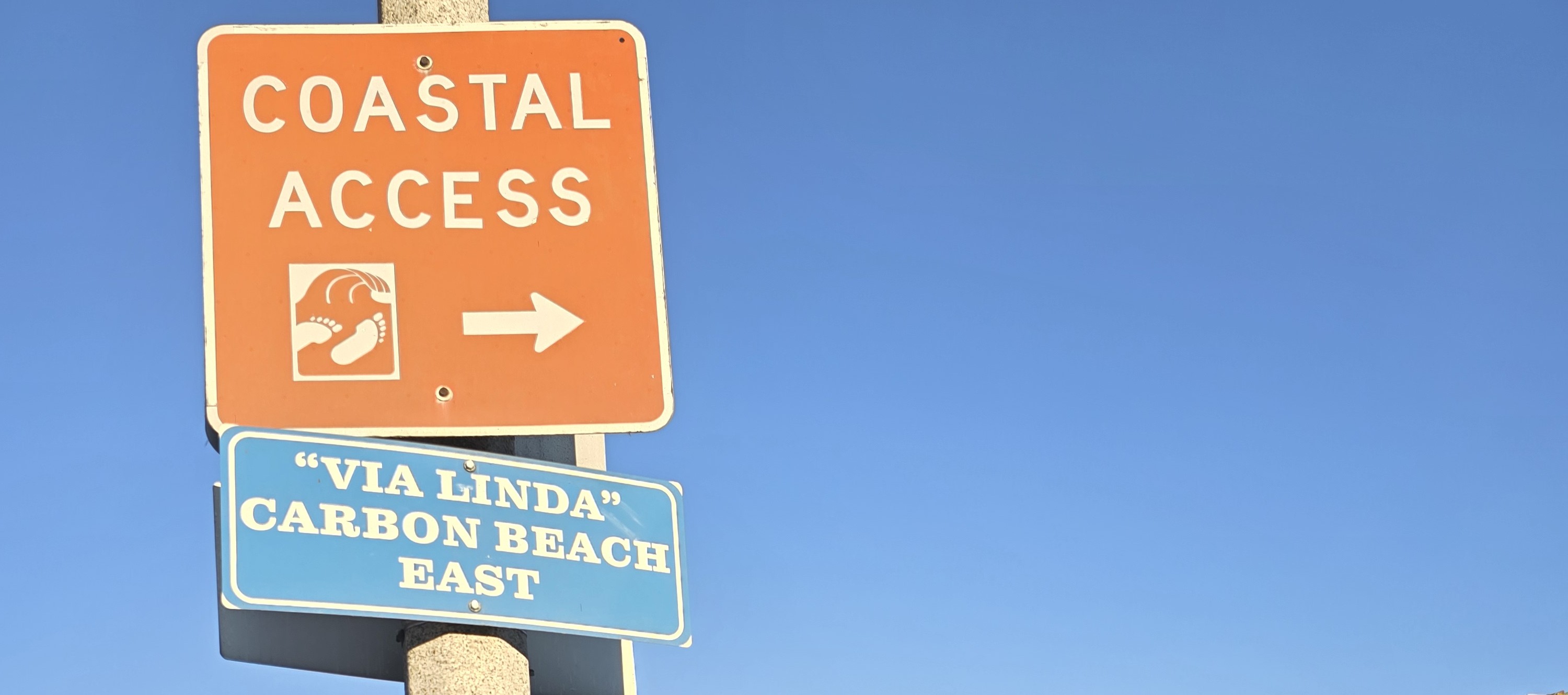 The Coastal Act 50th anniversary logo is atop a photo of children running along the beach at sunset