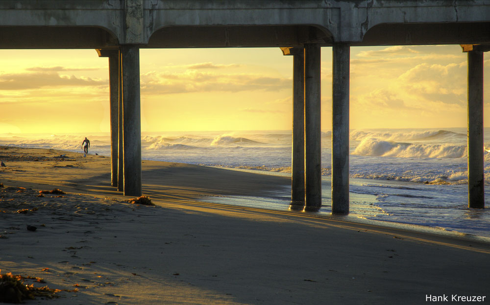 Photo of surfer walking near Huntington Beach Pier, by Hank Kreuzer