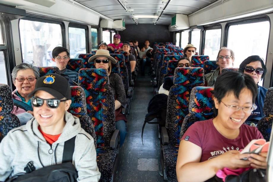Smiling people on the shuttle bus