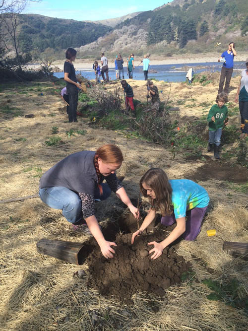 Students and leaders working near the river