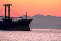 Graphic of a ship coming into port at sunset