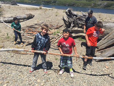 Kids with driftwood on the beach